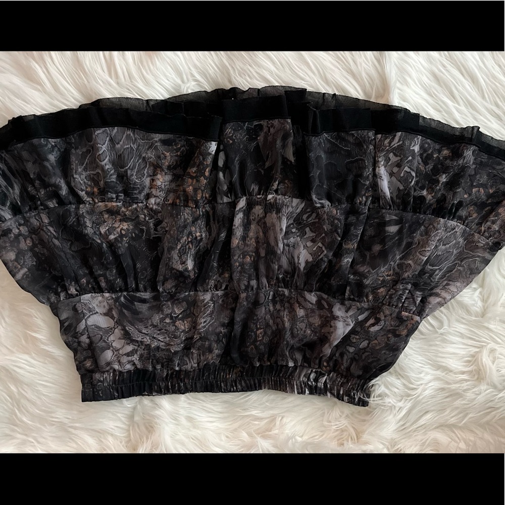 Black mini skirt with silver and gold accent .